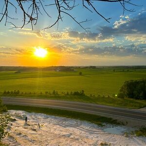 Vibrant Sunset Over Green Fields Art Print